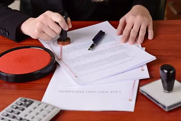 person stamping a document on a desk